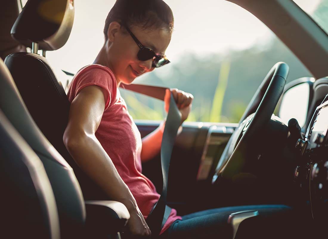 It’s Your Turn to Earn Rewards - Young Woman Driver Buckling up Her Seat Belt Before Getting Ready to Drive Her Car on a Sunny Day at Sunset